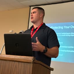 Jordan Schmitt, speaking at a lectern.